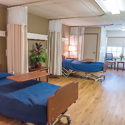 Shared bedroom with matching blue bedspreads at 60 West facility